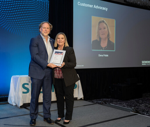 Dena Pollak accepting a Customer Advocacy award at SGT's annual awards program
